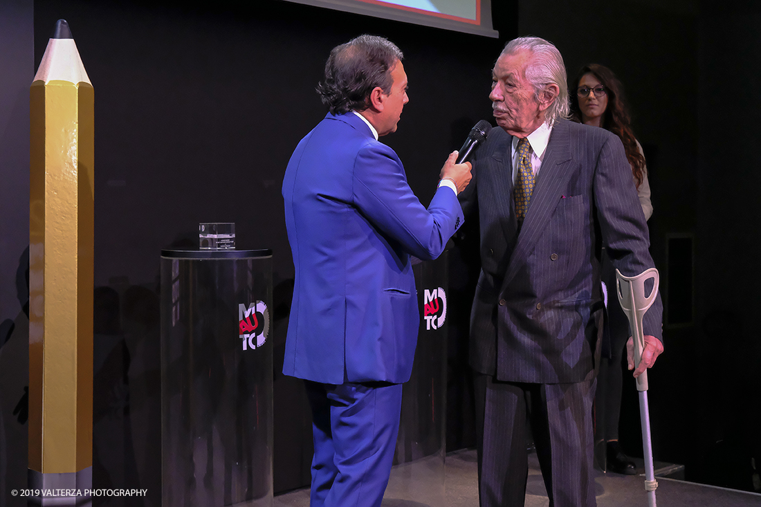 _DSF1350.jpg - 15/10/2019. Torino. Matita d'oro 2019. Anche quest'anno il Mauto ha assegnato i suoi prestigiosi premi al mondo dell'automobile. Nella foto Il premio Mauto 2019 per la fotografia va a Giorgio Bella per lâ€™originale interpretazione dellâ€™automobile che Giorgio Bellia ha saputo dare in qualitÃ  di artista fotografo. Giorgio Bellia ha realizzato scatti inediti e sorprendenti con le piÃ¹ belle vetture degli anni â€™60, â€™70 e â€™80, rendendo omaggio al design dellâ€™automobile attraverso immagini inconsuete, vere e proprie opere dâ€™arte. Giorgio Bellia ha voluto donare al Mauto il suo eccezionale archivio fotografico.a lui Ã¨ dedicata la mostra GIORGIO BELLIA | ARTISTA FOTOGRAFO UN FILTRO INEDITO SUL MONDO DELLâ€™AUTO, inaugurata in occasione della consegna del Premio, visitabile al MAUTO dal 16 ottobre 2019 al 12 gennaio 2020