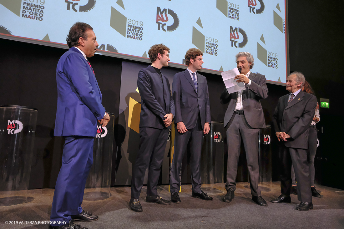 _DSF1477.jpg - 15/10/2019. Torino. Matita d'oro 2019. Anche quest'anno il Mauto ha assegnato i suoi prestigiosi premi al mondo dell'automobile. Nella foto Il  premio MAUTO "Avvocato Giovanni Agnelli 2019"  va a Sergio Pininfarina e Luca Campana giovani promesse del design per lâ€™innovativo progetto TUC.technology. un connettore modulabile che incrementa lâ€™intero sistema elettronico dei veicoli abilitandoli alla digitalizzazione e a unâ€™elevata personalizzazione. Consegnano il premio Benedetto Camerana ed Aldo Brovarone.