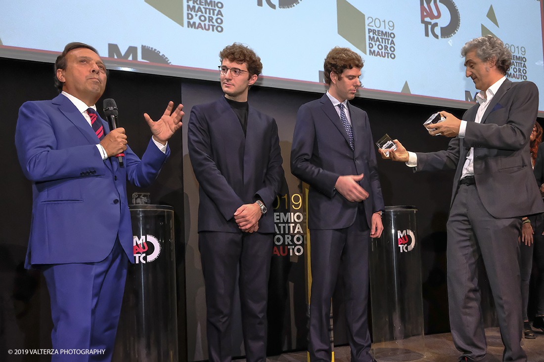 _DSF1488.jpg - 15/10/2019. Torino. Matita d'oro 2019. Anche quest'anno il Mauto ha assegnato i suoi prestigiosi premi al mondo dell'automobile. Nella foto Il  premio MAUTO "Avvocato Giovanni Agnelli 2019"  va a Sergio Pininfarina e Luca Campana giovani promesse del design per lâ€™innovativo progetto TUC.technology. un connettore modulabile che incrementa lâ€™intero sistema elettronico dei veicoli abilitandoli alla digitalizzazione e a unâ€™elevata personalizzazione. Consegnano il premio Benedetto Camerana ed Aldo Brovarone.