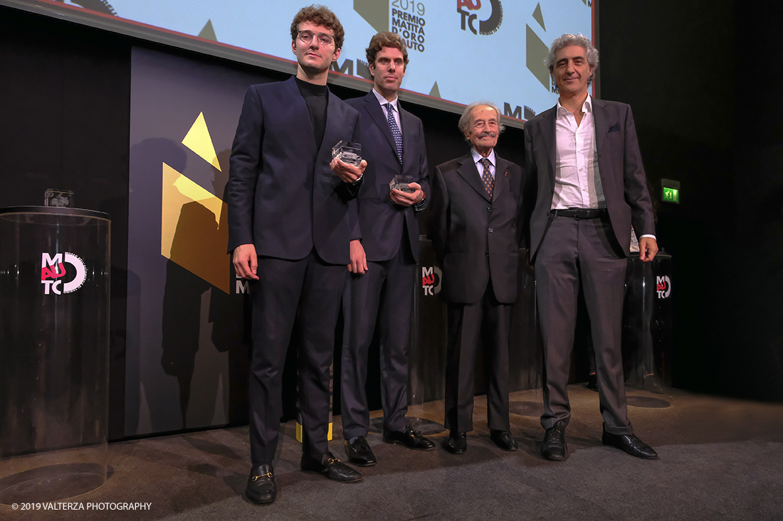 _DSF1503.jpg - 15/10/2019. Torino. Matita d'oro 2019. Anche quest'anno il Mauto ha assegnato i suoi prestigiosi premi al mondo dell'automobile. Nella foto Il  premio MAUTO "Avvocato Giovanni Agnelli 2019"  va a Sergio Pininfarina e Luca Campana giovani promesse del design per lâ€™innovativo progetto TUC.technology. un connettore modulabile che incrementa lâ€™intero sistema elettronico dei veicoli abilitandoli alla digitalizzazione e a unâ€™elevata personalizzazione. Consegnano il premio Benedetto Camerana ed Aldo Brovarone.