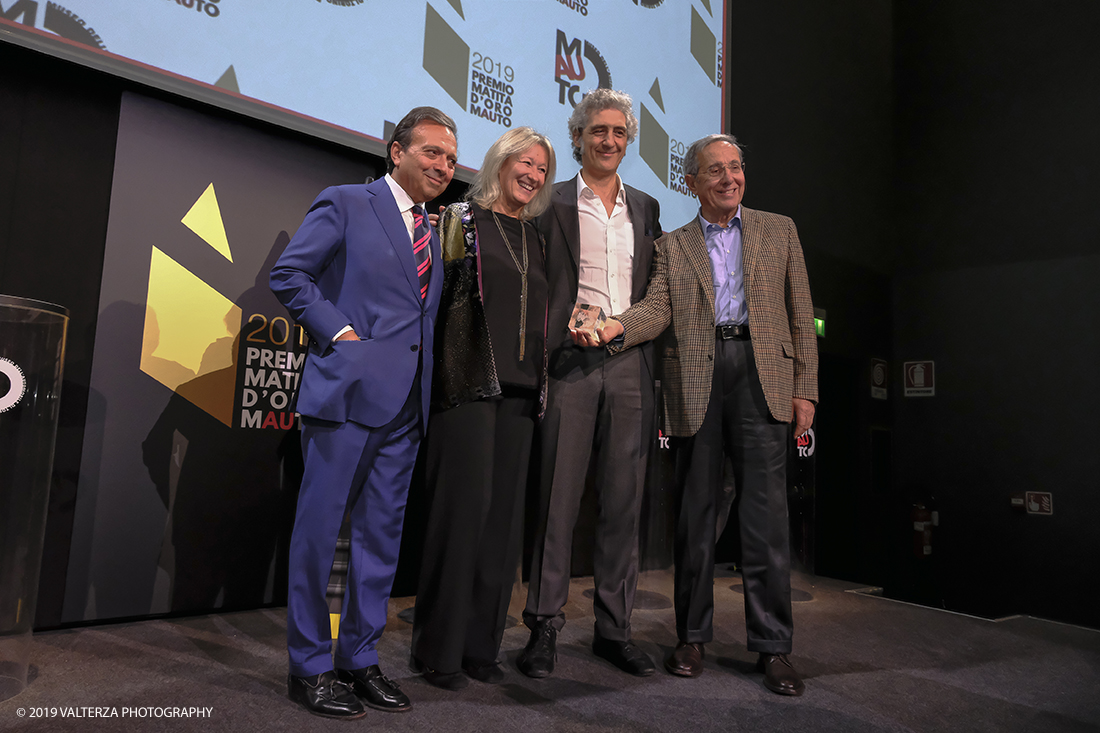 _DSF1582.jpg - 15/10/2019. Torino. Matita d'oro 2019. Anche quest'anno il Mauto ha assegnato i suoi prestigiosi premi al mondo dell'automobile. Nella foto Il premio MAUTO â€œCarlo Biscaretti di Ruffiaâ€� va allâ€™ Ing Mauro Forghieri  lâ€™insuperabile creativitÃ  ingegneristica e gli straordinari successi ottenuti su strada e su pista: durante gli anni in cui Ã¨ stato Direttore Tecnico della Scuderia Ferrari. Consegnano il premio  Mariella Mengozzi e Benedetto Camerana.