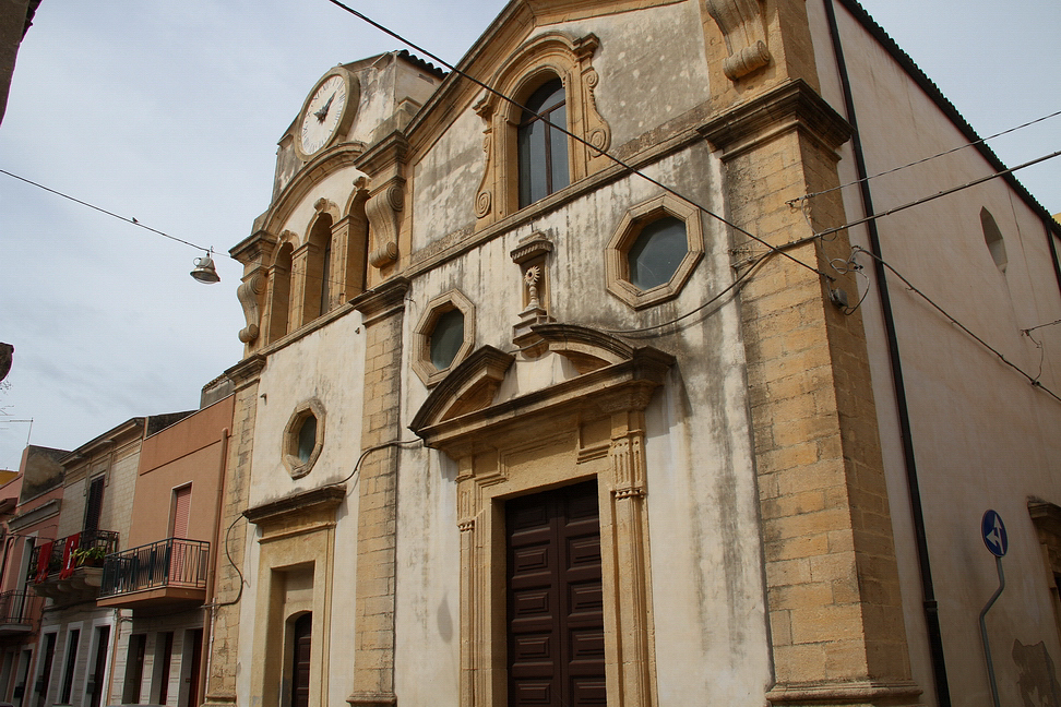 Sicilia_071.JPG - Chiesa di San Sebastiano costruita nel 1719 sulle rovine della antica chiesa dedicata al SS. Sacramento come ancora si vede dall'ostensorio in pietra incastonato in una nicchia.  La facciata è costituita da due distinti corpi affiancati separati da lesene in pietra arenaria